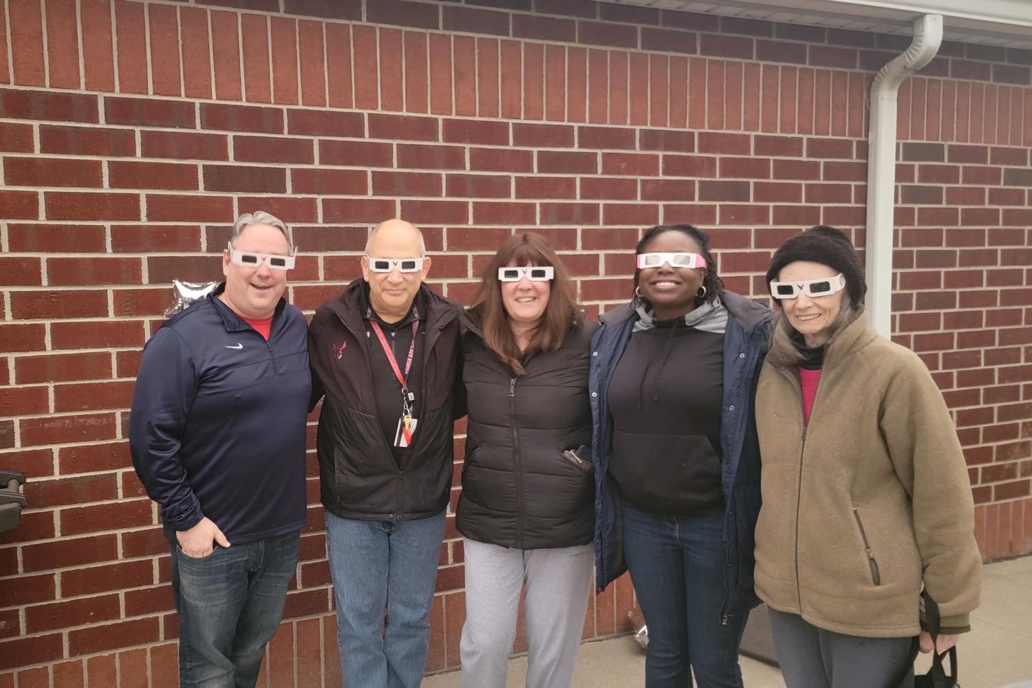 Roberts Faculty Staff and Maryann Hayles in eclipse glasses